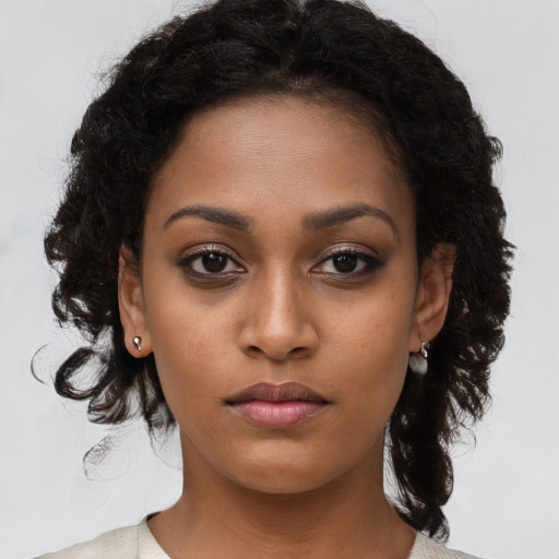 Neutral black young-adult female with medium  brown hair and brown eyes