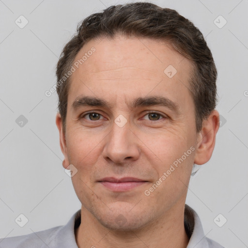 Joyful white adult male with short  brown hair and brown eyes