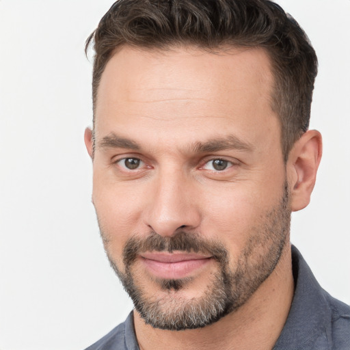 Joyful white adult male with short  brown hair and brown eyes