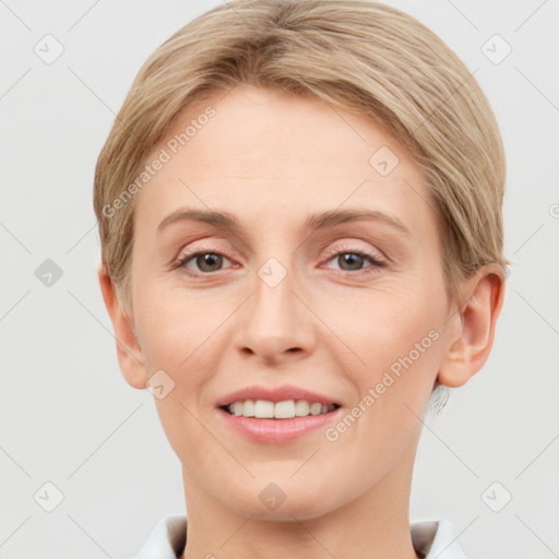 Joyful white adult female with short  brown hair and grey eyes