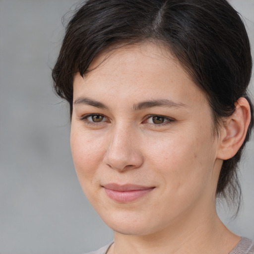 Joyful white young-adult female with medium  brown hair and brown eyes