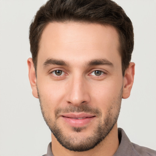 Joyful white young-adult male with short  brown hair and brown eyes