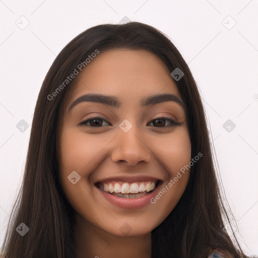 Joyful latino young-adult female with long  brown hair and brown eyes