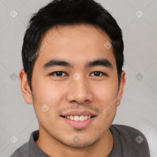 Joyful asian young-adult male with short  black hair and brown eyes