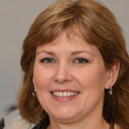 Joyful white adult female with medium  brown hair and brown eyes