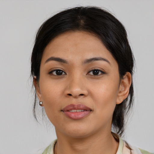 Joyful asian young-adult female with medium  brown hair and brown eyes