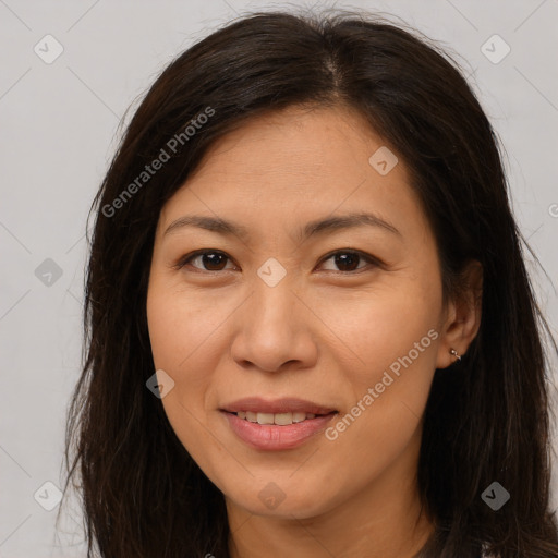 Joyful white adult female with long  brown hair and brown eyes