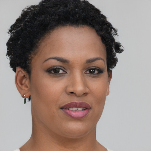 Joyful black young-adult female with short  brown hair and brown eyes