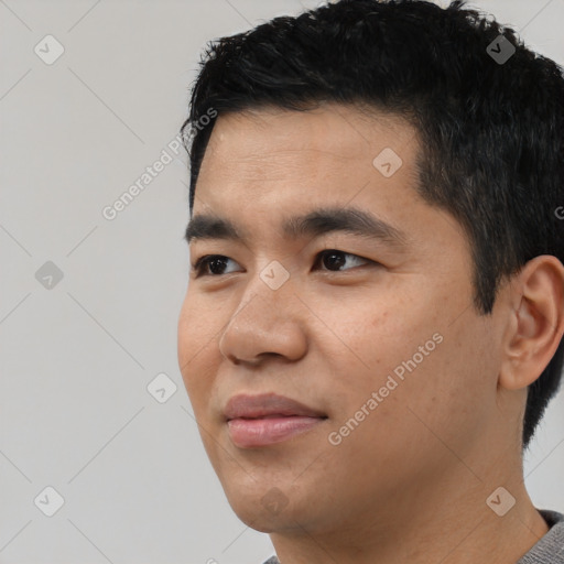 Joyful asian young-adult male with short  black hair and brown eyes