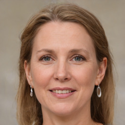 Joyful white adult female with medium  brown hair and grey eyes