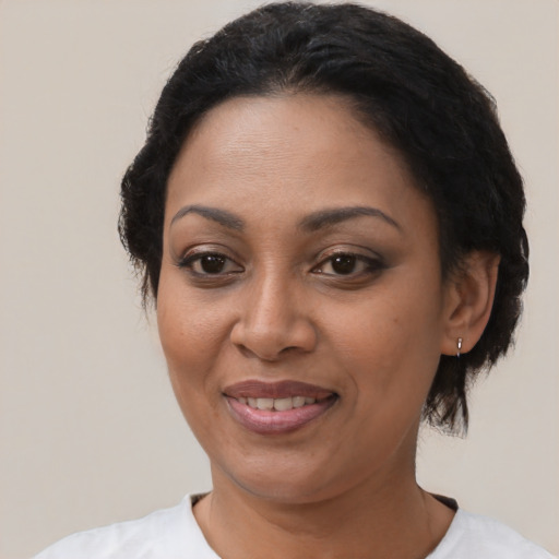 Joyful latino adult female with short  black hair and brown eyes