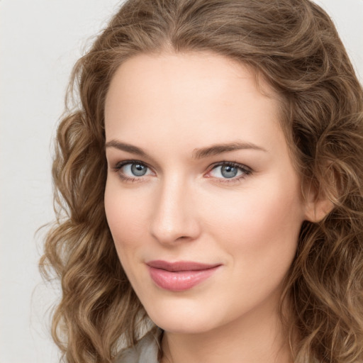 Joyful white young-adult female with long  brown hair and green eyes