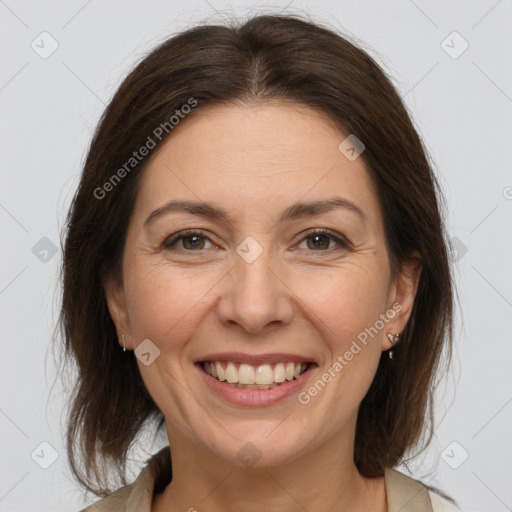 Joyful white adult female with medium  brown hair and brown eyes