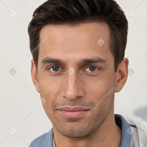 Joyful white young-adult male with short  brown hair and brown eyes