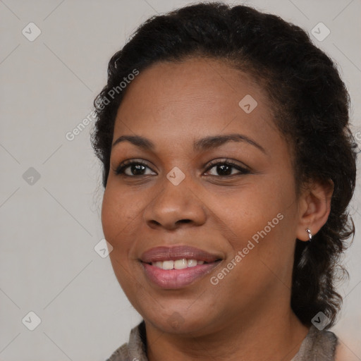 Joyful black young-adult female with long  brown hair and brown eyes