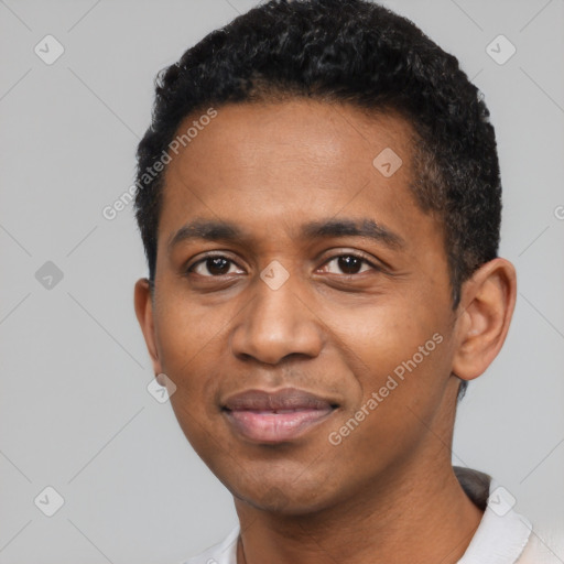 Joyful black young-adult male with short  black hair and brown eyes