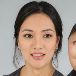 Joyful asian young-adult female with medium  black hair and brown eyes