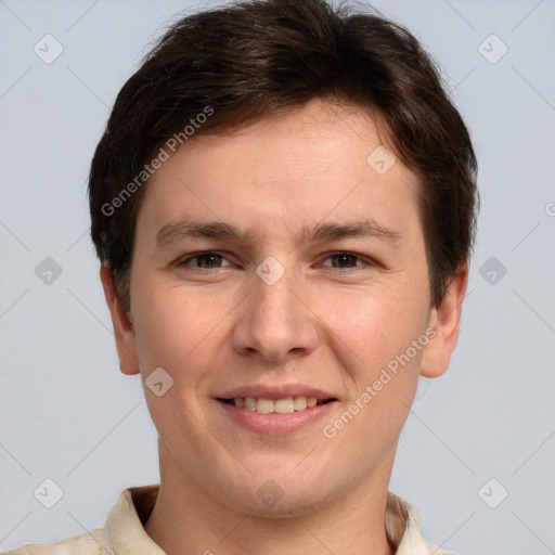 Joyful white young-adult male with short  brown hair and grey eyes