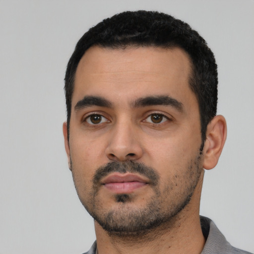 Neutral latino young-adult male with short  black hair and brown eyes