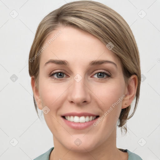 Joyful white young-adult female with medium  brown hair and grey eyes