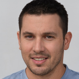 Joyful white young-adult male with short  brown hair and brown eyes