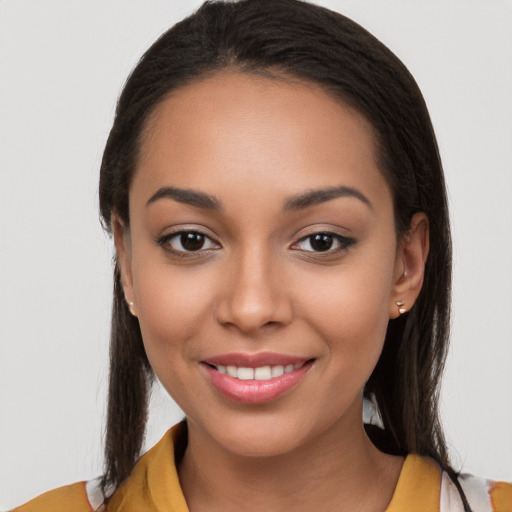 Joyful latino young-adult female with long  brown hair and brown eyes