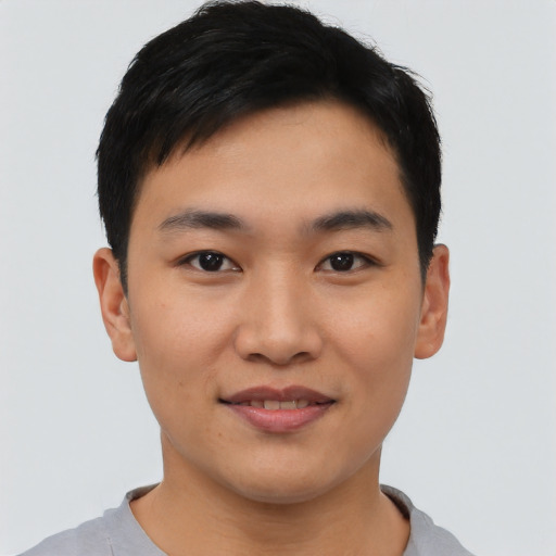 Joyful asian young-adult male with short  black hair and brown eyes