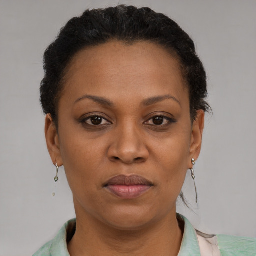 Joyful black adult female with short  brown hair and brown eyes