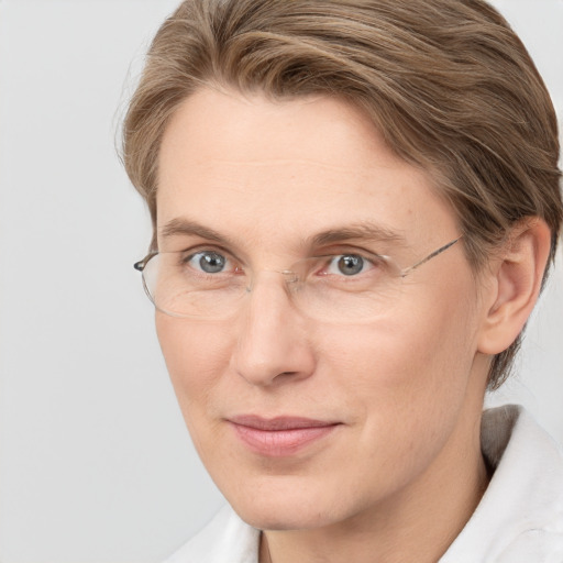 Joyful white adult female with short  brown hair and grey eyes