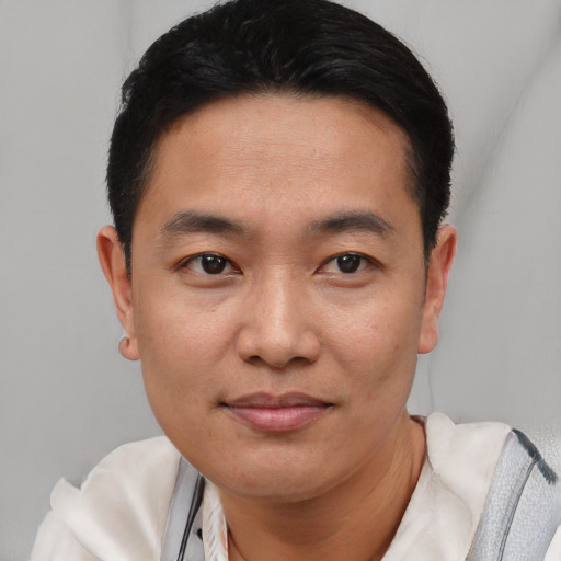 Joyful latino young-adult male with short  black hair and brown eyes