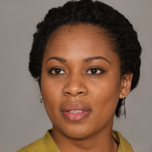 Joyful black young-adult female with short  black hair and brown eyes