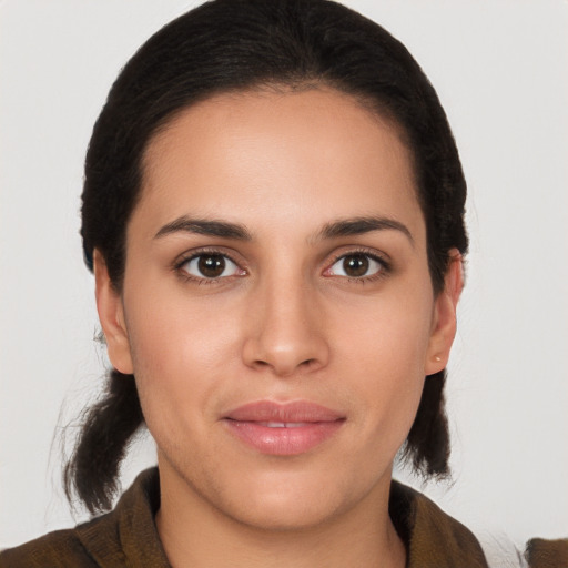 Joyful latino young-adult female with medium  brown hair and brown eyes