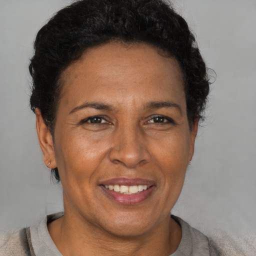 Joyful black adult female with short  brown hair and brown eyes