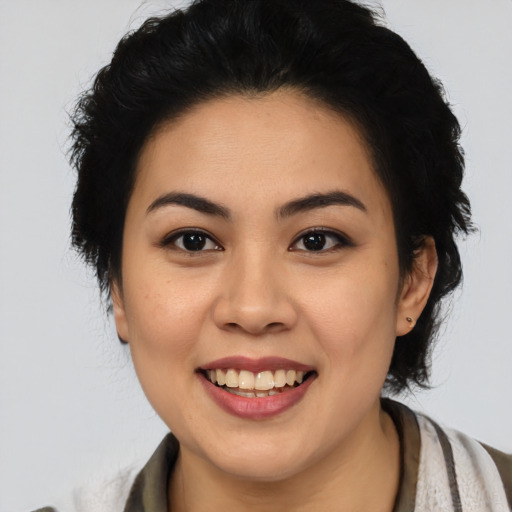 Joyful latino young-adult female with medium  black hair and brown eyes