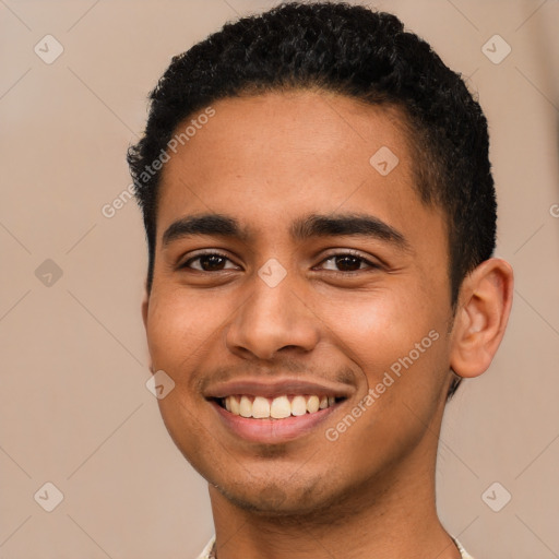 Joyful latino young-adult male with short  brown hair and brown eyes