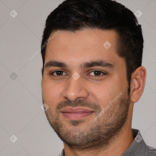 Joyful white young-adult male with short  black hair and brown eyes