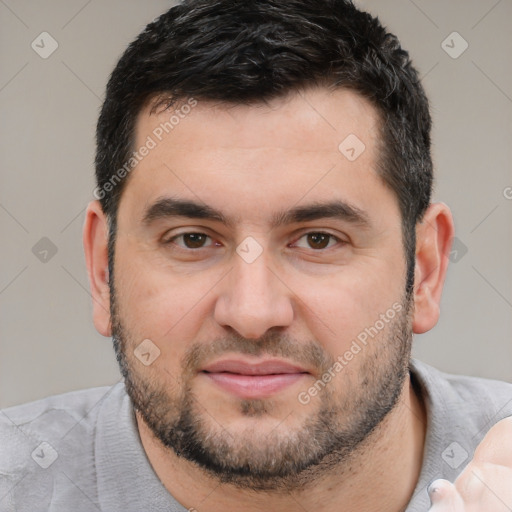 Joyful white young-adult male with short  black hair and brown eyes