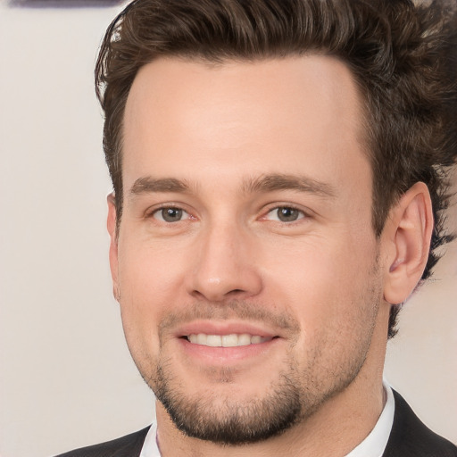 Joyful white young-adult male with short  brown hair and brown eyes