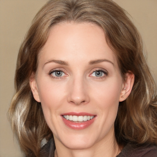 Joyful white adult female with medium  brown hair and grey eyes