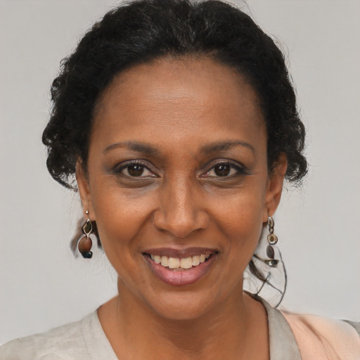 Joyful black adult female with short  brown hair and brown eyes