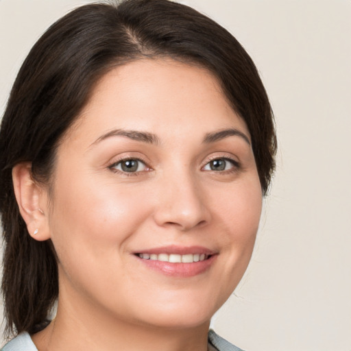 Joyful white young-adult female with medium  brown hair and brown eyes