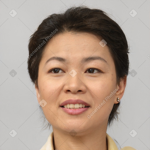 Joyful white adult female with medium  brown hair and brown eyes