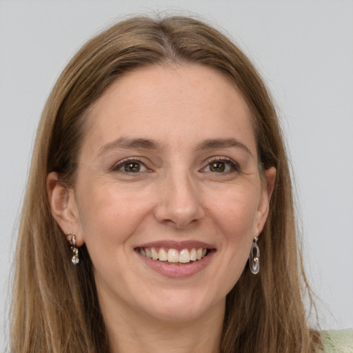 Joyful white young-adult female with long  brown hair and grey eyes