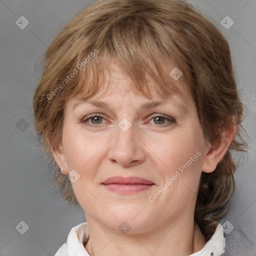 Joyful white adult female with medium  brown hair and blue eyes