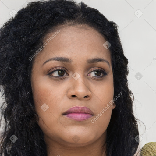 Joyful black young-adult female with long  brown hair and brown eyes