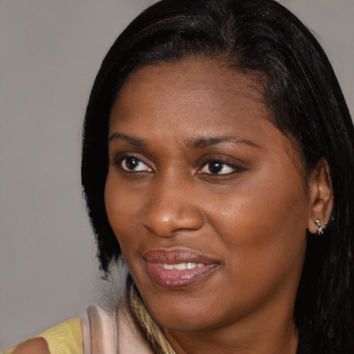 Joyful black young-adult female with medium  brown hair and brown eyes