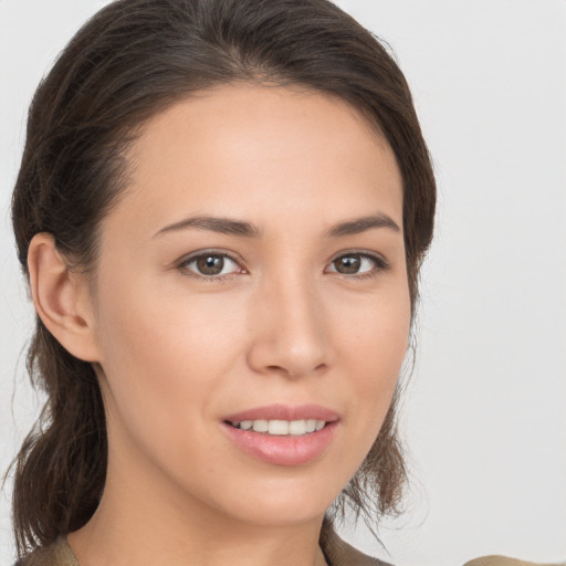 Joyful white young-adult female with medium  brown hair and brown eyes