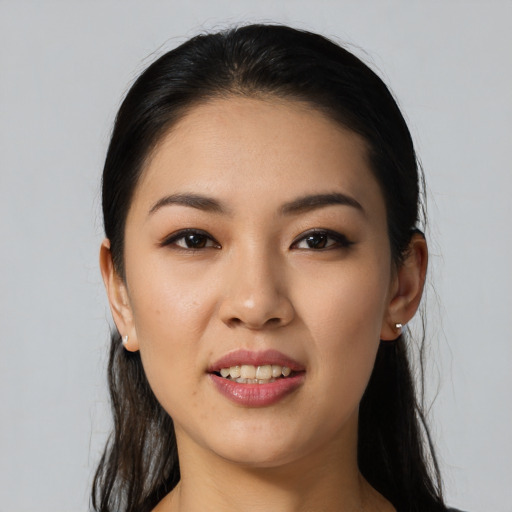 Joyful white young-adult female with long  black hair and brown eyes