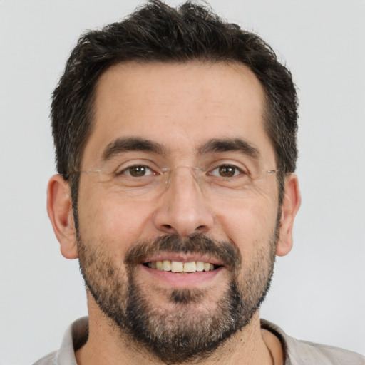 Joyful white adult male with short  brown hair and brown eyes