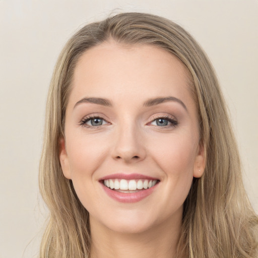 Joyful white young-adult female with long  brown hair and green eyes